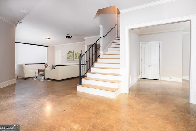 stairs featuring concrete floors, ornamental molding, and baseboards