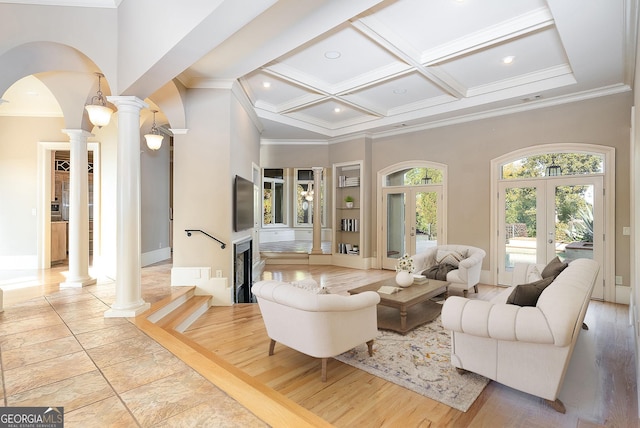 living room featuring ornate columns, a towering ceiling, arched walkways, ornamental molding, and coffered ceiling
