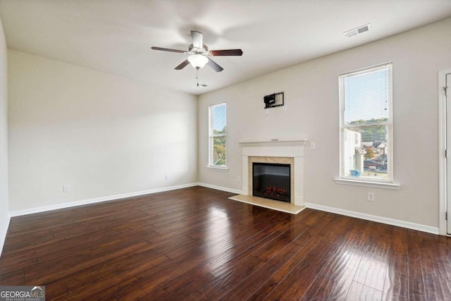 unfurnished living room with dark wood-type flooring and ceiling fan