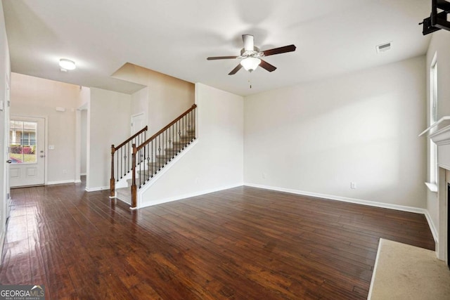 unfurnished living room featuring dark hardwood / wood-style floors and ceiling fan