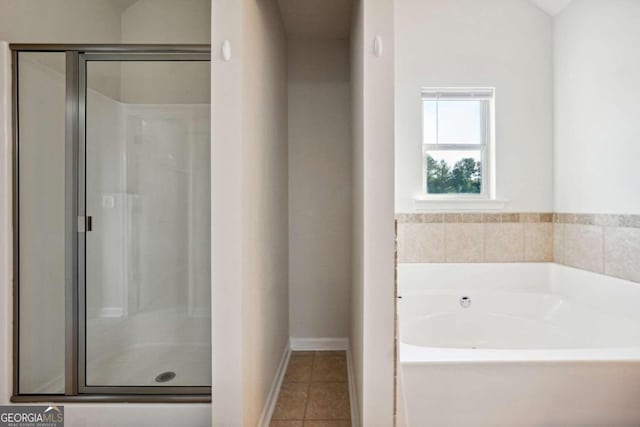 bathroom with independent shower and bath and tile patterned flooring