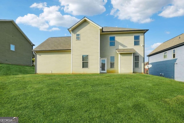 rear view of house with a lawn