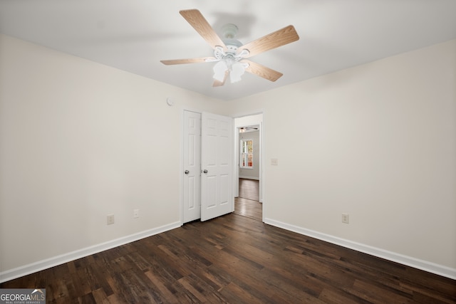 unfurnished room with ceiling fan and dark hardwood / wood-style flooring