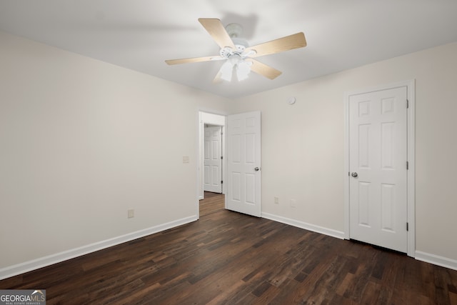 unfurnished bedroom with dark hardwood / wood-style flooring and ceiling fan