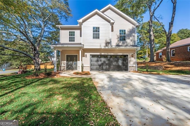 view of front of house featuring a garage and a front lawn