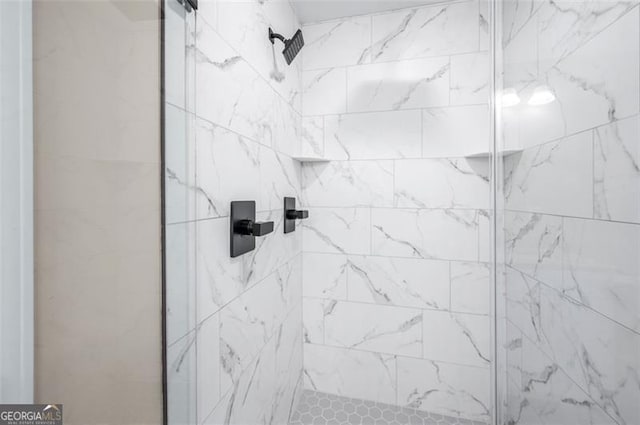 interior details featuring a tile shower