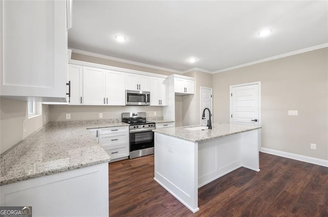 kitchen with a kitchen island with sink, sink, white cabinetry, and appliances with stainless steel finishes