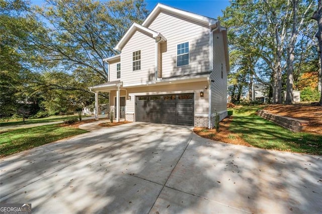 view of front of house with a garage and a front lawn