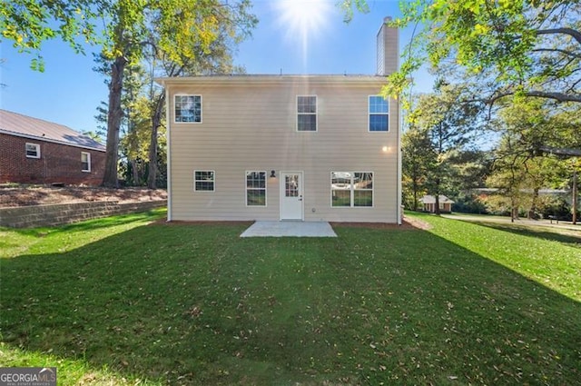 back of property featuring a yard and a patio