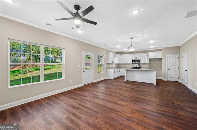 kitchen with crown molding, a center island, white cabinets, dark hardwood / wood-style flooring, and decorative light fixtures