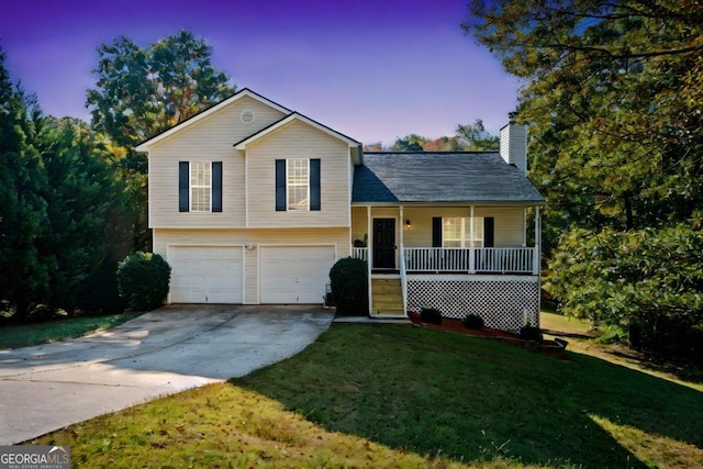 split level home with a yard, covered porch, and a garage