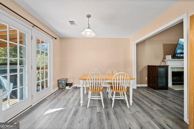 dining area featuring a textured ceiling and wood-type flooring