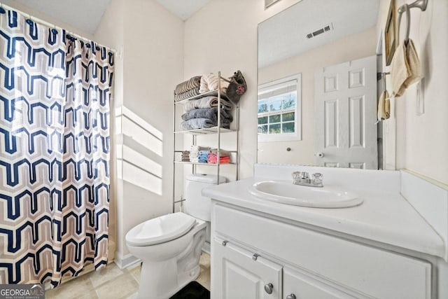 bathroom featuring vanity, a shower with shower curtain, toilet, and tile patterned floors