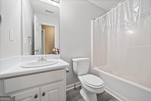 full bathroom featuring hardwood / wood-style floors, shower / tub combo, a textured ceiling, toilet, and vanity