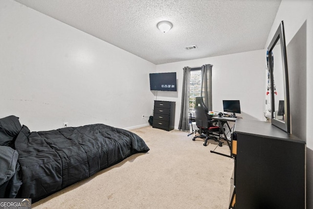 carpeted bedroom featuring a textured ceiling