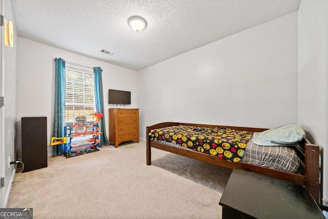 carpeted bedroom featuring a textured ceiling