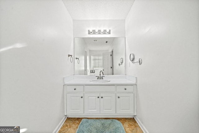 bathroom featuring vanity and a textured ceiling