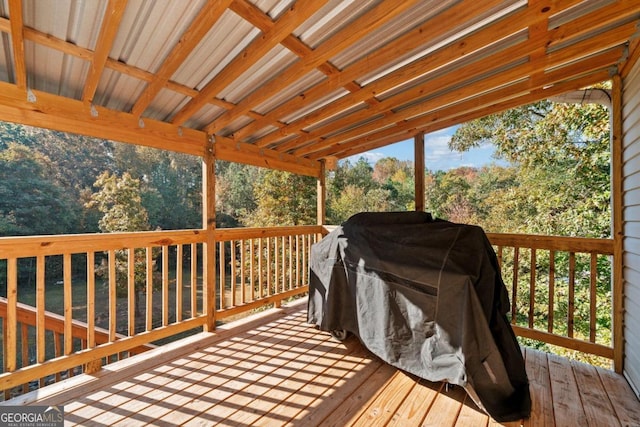 wooden deck featuring a grill