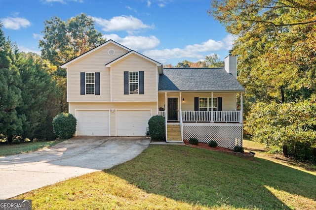 tri-level home featuring a porch, a front lawn, and a garage