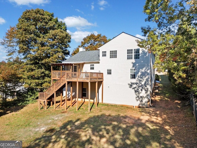 back of house featuring a deck and a lawn