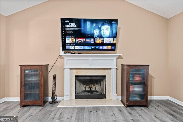 unfurnished living room featuring hardwood / wood-style flooring and vaulted ceiling