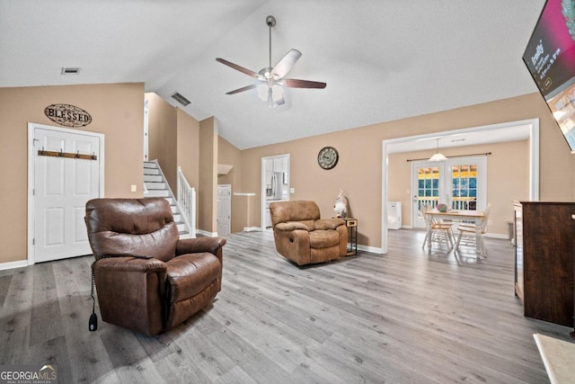 living room featuring french doors, hardwood / wood-style flooring, high vaulted ceiling, and ceiling fan