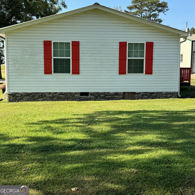 view of home's exterior featuring a yard