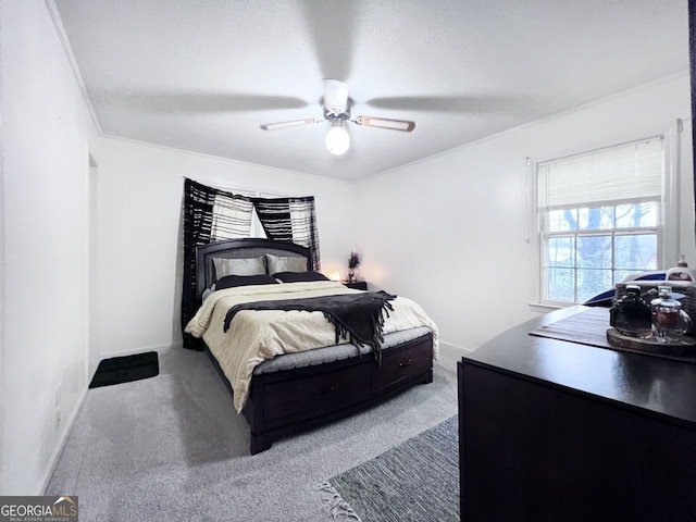 bedroom with ornamental molding, carpet, a textured ceiling, and ceiling fan