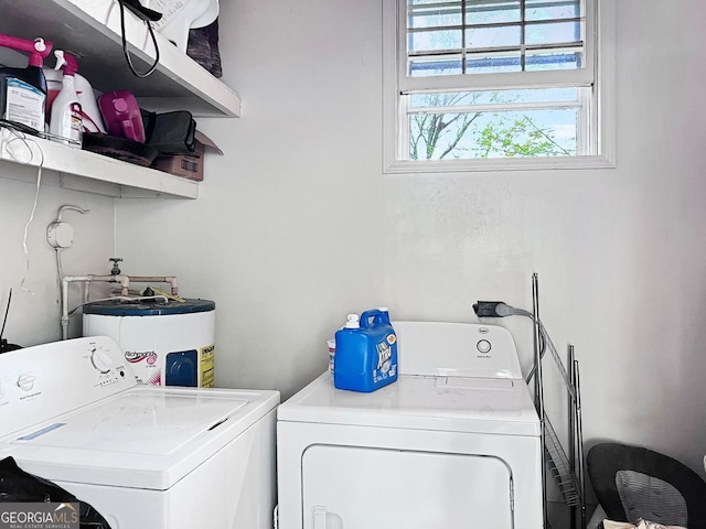 laundry room with washer and dryer and water heater