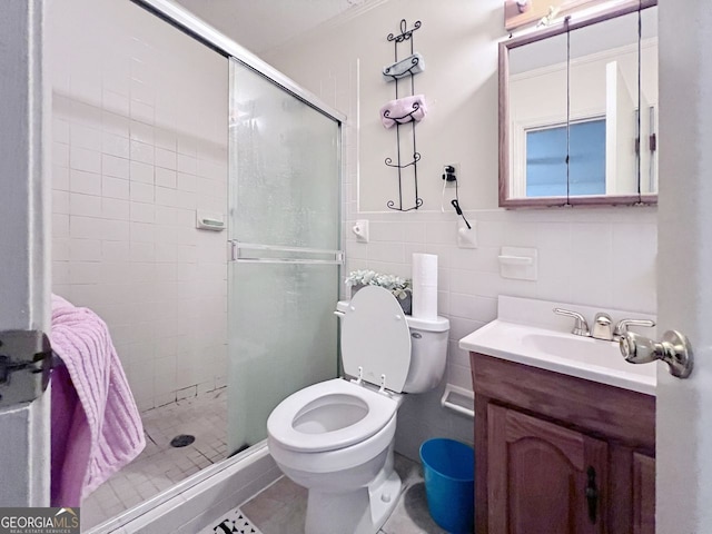 bathroom featuring tile patterned flooring, vanity, an enclosed shower, toilet, and tile walls