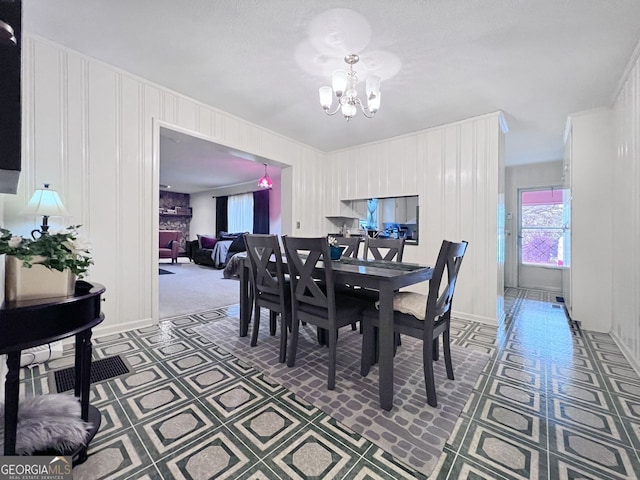 dining space featuring a chandelier and a textured ceiling