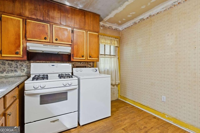 kitchen with white gas stove, washer / clothes dryer, and light hardwood / wood-style flooring