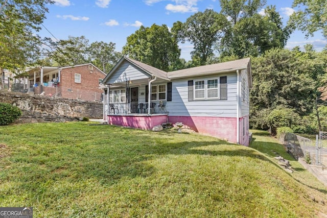 view of front of house featuring a front yard and covered porch