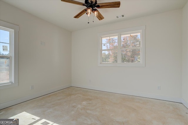 empty room with a wealth of natural light and ceiling fan