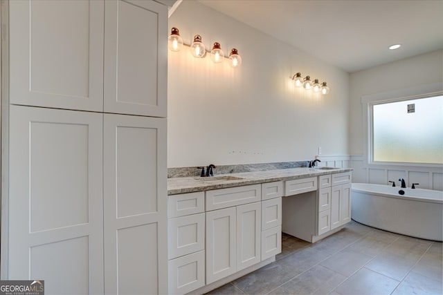 bathroom with vanity, a tub to relax in, and tile patterned floors