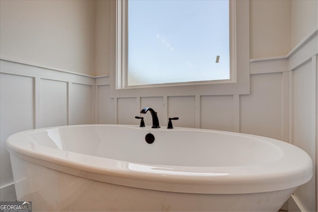 bathroom with a tub to relax in