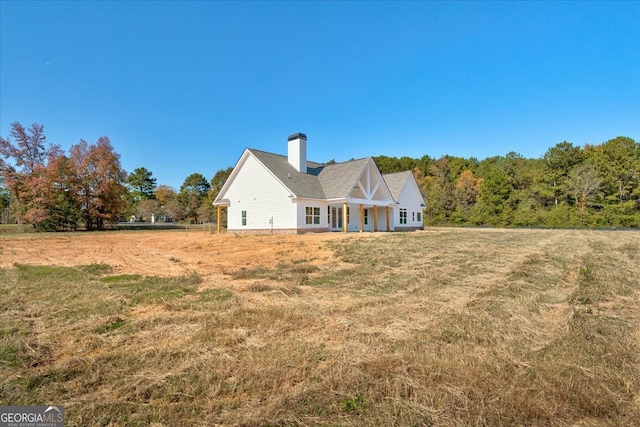 rear view of house with a lawn