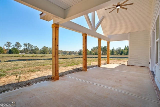 view of patio / terrace featuring ceiling fan and a rural view