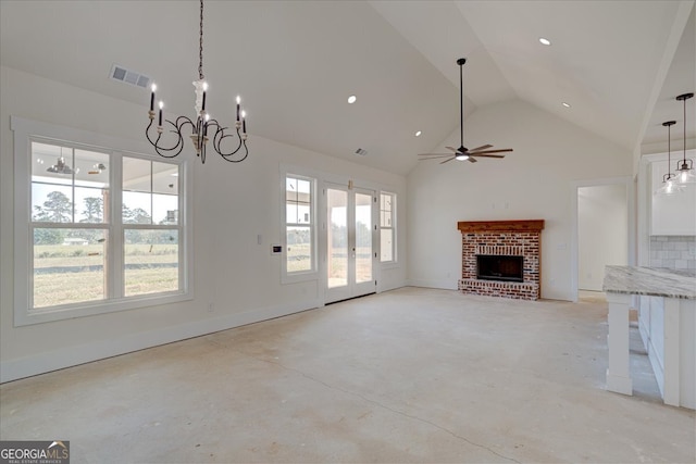 unfurnished living room with high vaulted ceiling, ceiling fan with notable chandelier, and a brick fireplace