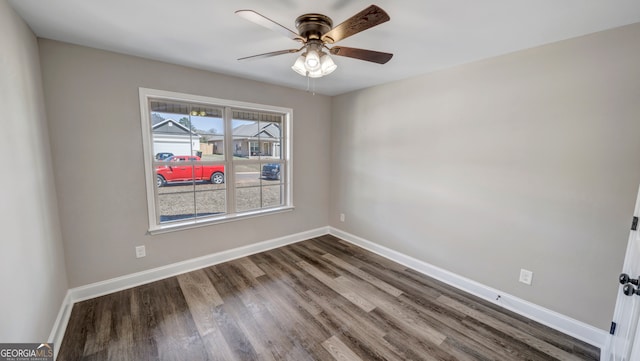 spare room featuring a wealth of natural light, hardwood / wood-style floors, and ceiling fan