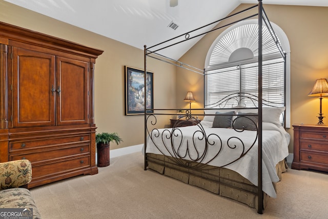 bedroom featuring light carpet and vaulted ceiling