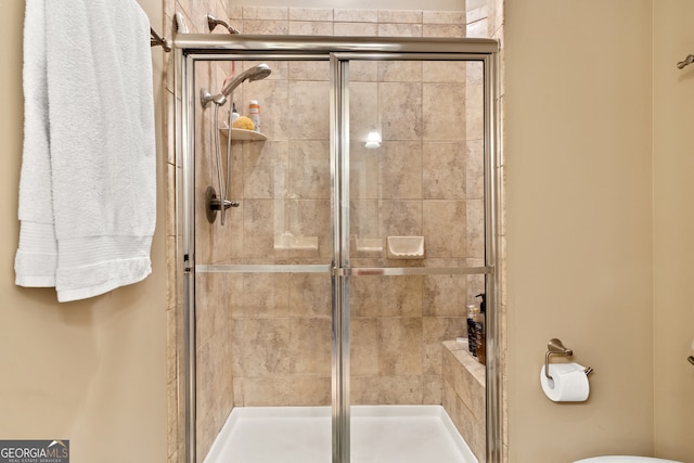 bathroom with a shower with shower door