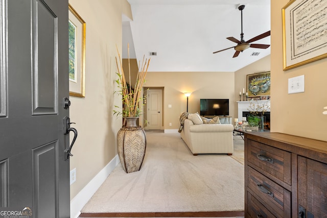 carpeted living room with high vaulted ceiling and ceiling fan