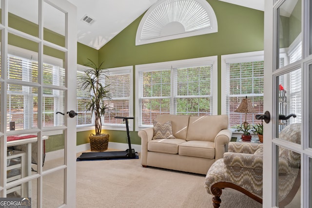 sunroom with french doors, a healthy amount of sunlight, and vaulted ceiling