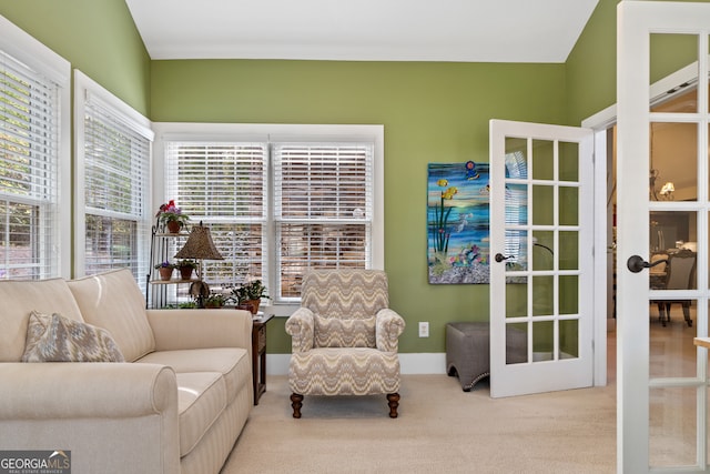 sitting room with light colored carpet and french doors