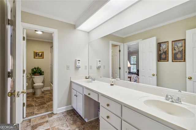 bathroom featuring vanity, toilet, and ornamental molding