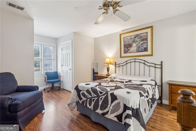 bedroom featuring ceiling fan, dark hardwood / wood-style flooring, and a closet