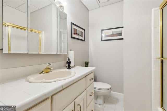 bathroom with tile patterned flooring, vanity, toilet, and an enclosed shower