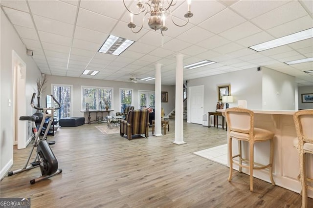 456 N Saint Marys Ln, Marietta, GA 30064 - interior space featuring wood finished floors, a drop ceiling, a chandelier, decorative columns, and a dry bar