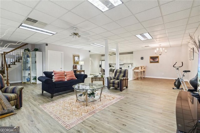 456 N Saint Marys Ln, Marietta, GA 30064 - living area with light wood-style flooring, stairs, baseboards, a chandelier, and a paneled ceiling